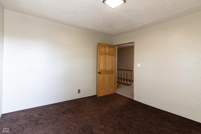 empty room featuring dark carpet