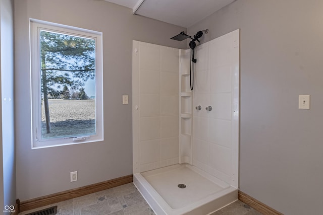 bathroom featuring baseboards, visible vents, and a shower stall
