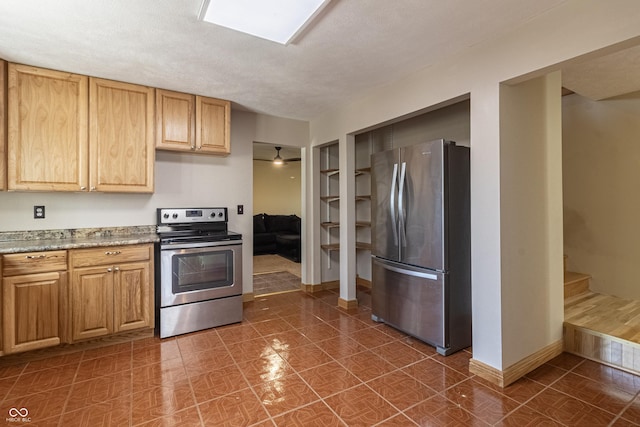 kitchen with light countertops, baseboards, and stainless steel appliances