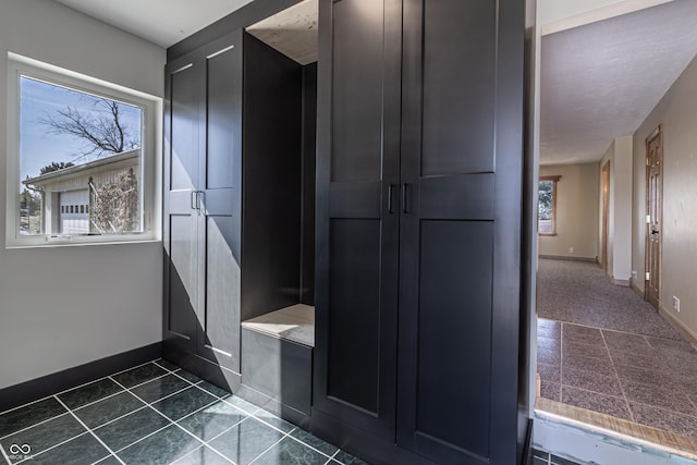 bathroom with baseboards and tile patterned floors