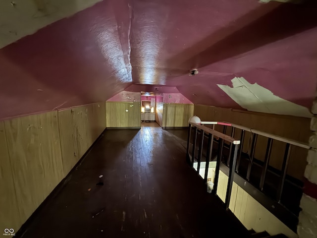 additional living space featuring wood finished floors and lofted ceiling