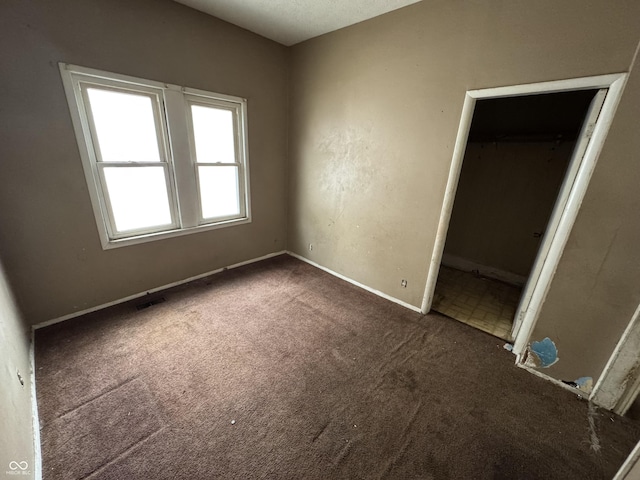unfurnished bedroom with baseboards and carpet