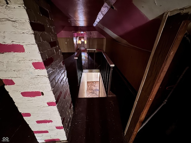 stairway with vaulted ceiling