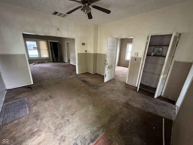 interior space featuring visible vents, plenty of natural light, and ceiling fan