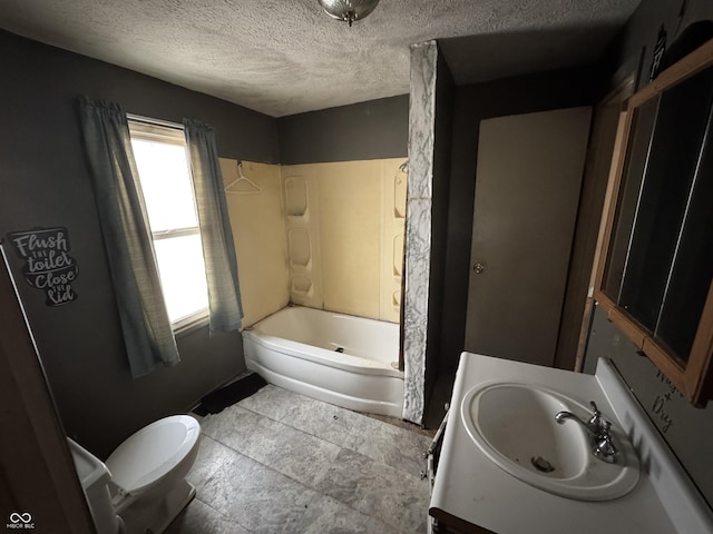 bathroom featuring a healthy amount of sunlight, toilet, and a textured ceiling