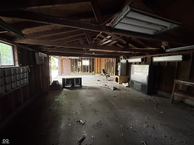 misc room featuring a garage and lofted ceiling