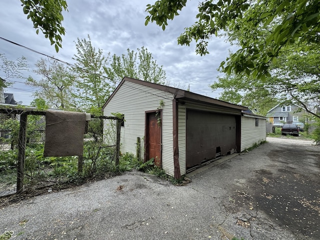detached garage featuring fence