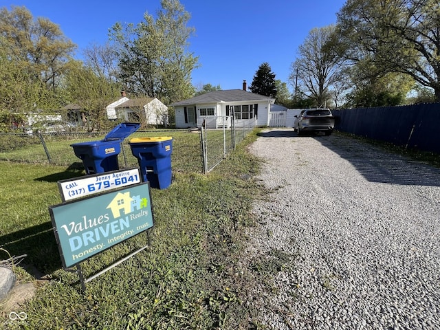 exterior space with fence and gravel driveway