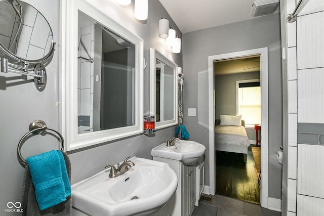 319 S Randolph St, Indianapolis, IN 46201 - full bathroom featuring tile patterned floors, two sinks, and connected bathroom
