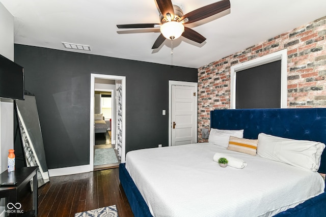 319 S Randolph St, Indianapolis, IN 46201 - bedroom with a ceiling fan, brick wall, visible vents, and hardwood / wood-style floors