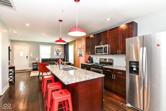319 S Randolph St, Indianapolis, IN 46201 - kitchen featuring a sink, an island with sink, stainless steel appliances, a kitchen bar, and visible vents