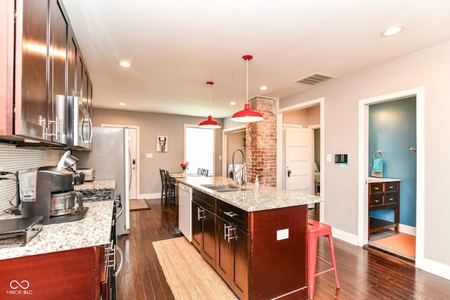319 S Randolph St, Indianapolis, IN 46201 - kitchen featuring visible vents, a kitchen breakfast bar, a center island with sink, a sink, and appliances with stainless steel finishes