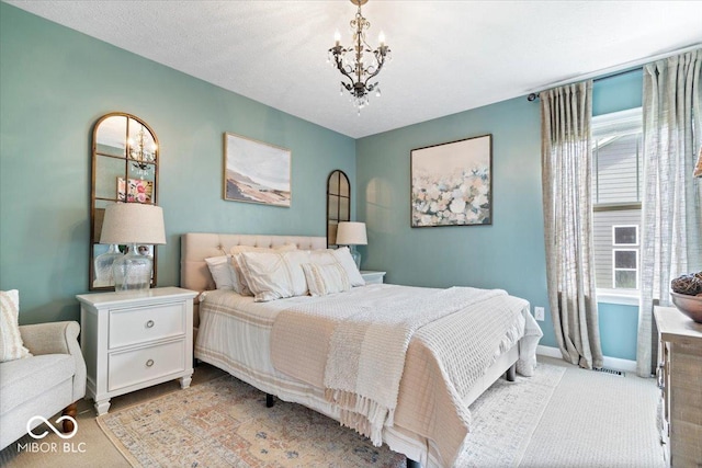 bedroom with an inviting chandelier and baseboards