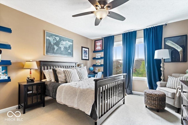 bedroom featuring carpet floors, a ceiling fan, baseboards, and a textured ceiling
