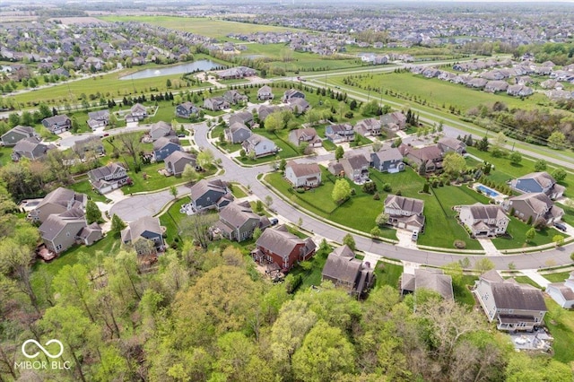 drone / aerial view featuring a water view and a residential view