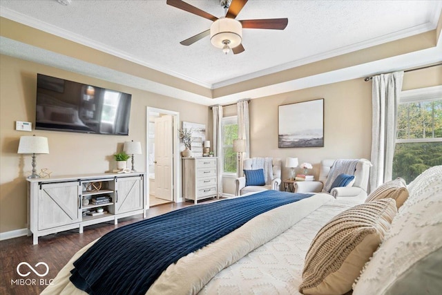 bedroom with crown molding, dark wood-style flooring, a textured ceiling, and multiple windows