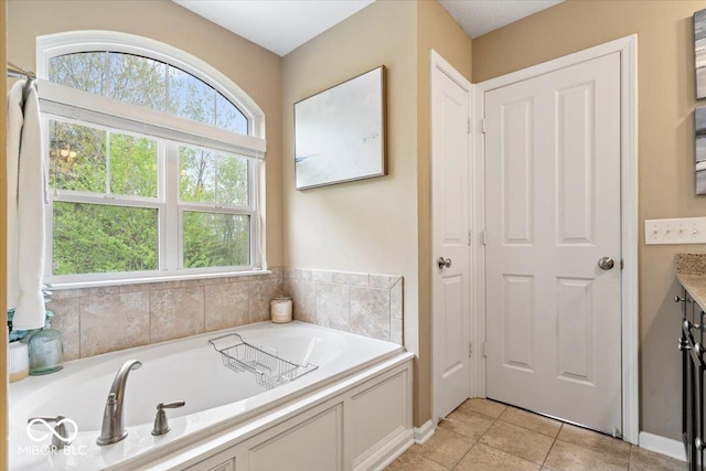 full bathroom with vanity, tile patterned floors, and a bath