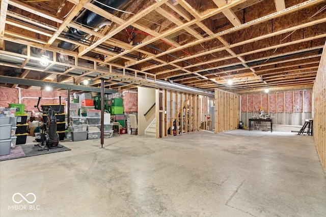 unfinished basement featuring stairway