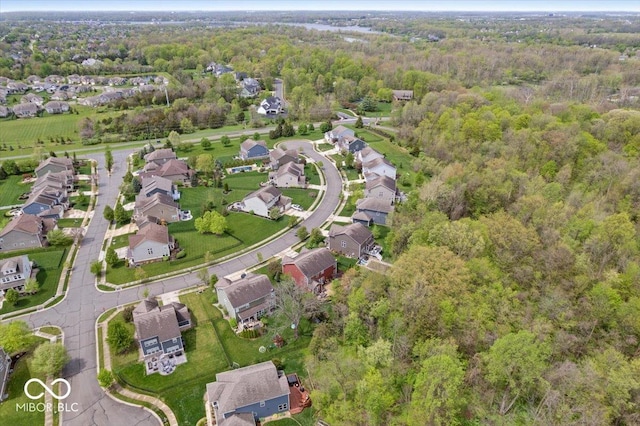 birds eye view of property featuring a residential view and a wooded view