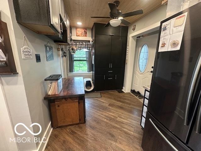 kitchen with wood ceiling, a ceiling fan, baseboards, freestanding refrigerator, and dark wood-style floors
