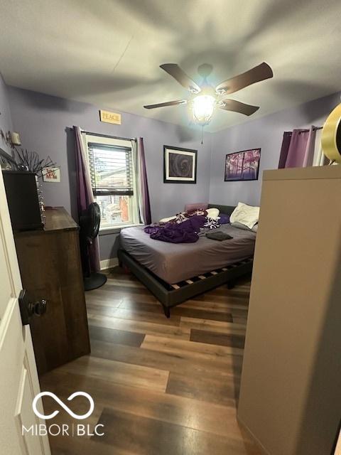 bedroom featuring a ceiling fan and wood finished floors