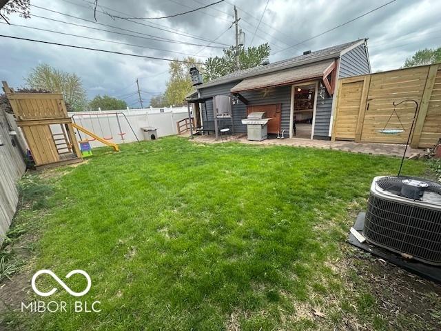view of yard featuring a fenced backyard and central AC