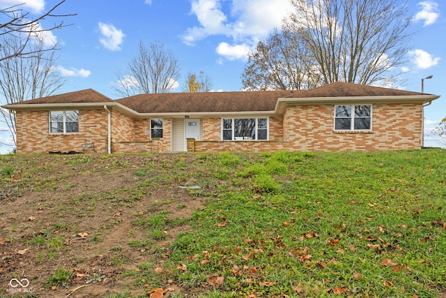 single story home featuring a front yard and brick siding