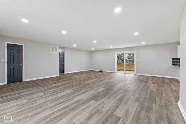 unfurnished living room featuring visible vents, recessed lighting, baseboards, and wood finished floors