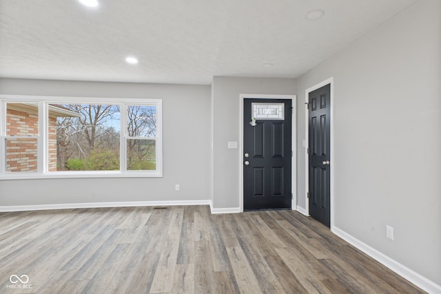 entrance foyer featuring baseboards, recessed lighting, and wood finished floors