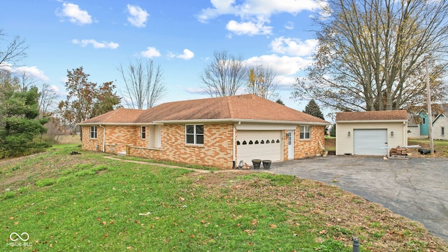 view of home's exterior featuring a lawn, brick siding, and aphalt driveway
