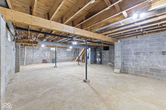 unfinished basement featuring water heater