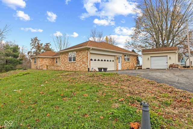 view of front facade with brick siding, a garage, aphalt driveway, and a front yard