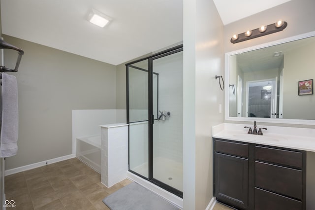 full bathroom featuring vanity, baseboards, a garden tub, and a stall shower