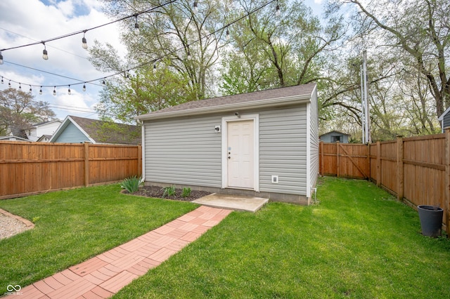 view of outdoor structure with a fenced backyard and an outdoor structure