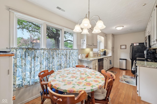 1030 Stratford Hall Unit 17-3, Indianapolis, IN 46260 - dining room with a chandelier, plenty of natural light, and light wood-type flooring