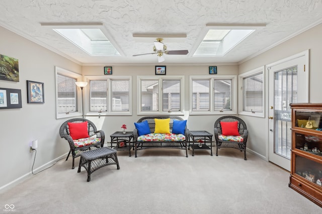 1030 Stratford Hall Unit 17-3, Indianapolis, IN 46260 - living area featuring a skylight, carpet floors, ceiling fan, baseboards, and a textured ceiling