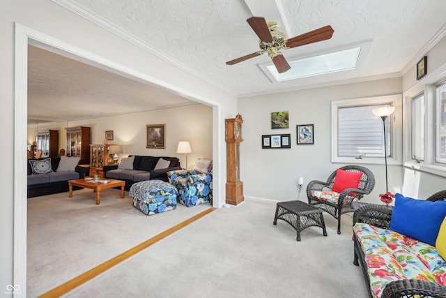1030 Stratford Hall Unit 17-3, Indianapolis, IN 46260 - carpeted living room with ceiling fan, a textured ceiling, a skylight, and ornamental molding
