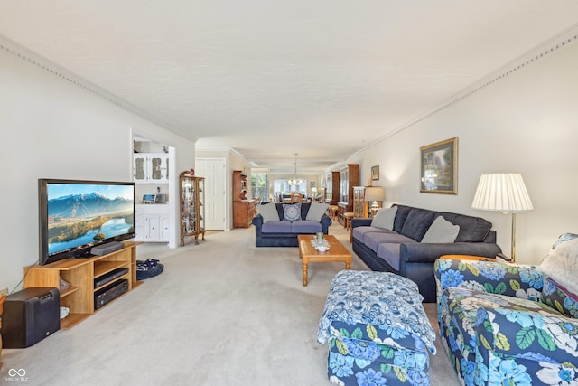 1030 Stratford Hall Unit 17-3, Indianapolis, IN 46260 - living room with crown molding, carpet floors, and a chandelier