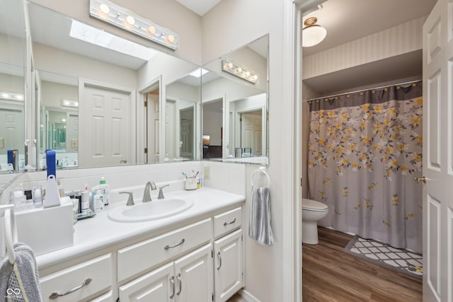 1030 Stratford Hall Unit 17-3, Indianapolis, IN 46260 - bathroom with toilet, wood finished floors, vanity, and a shower with curtain