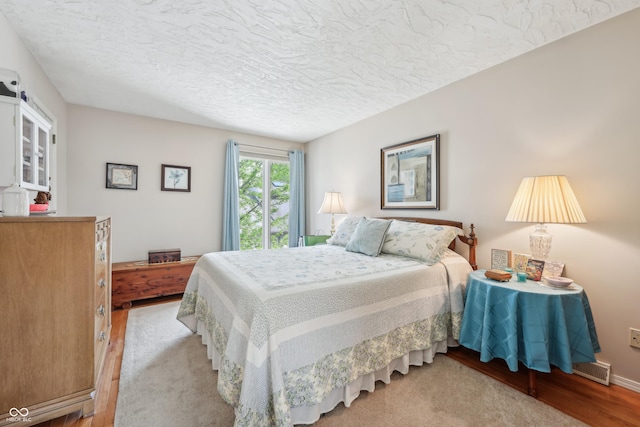 1030 Stratford Hall Unit 17-3, Indianapolis, IN 46260 - bedroom featuring a textured ceiling and light wood-type flooring