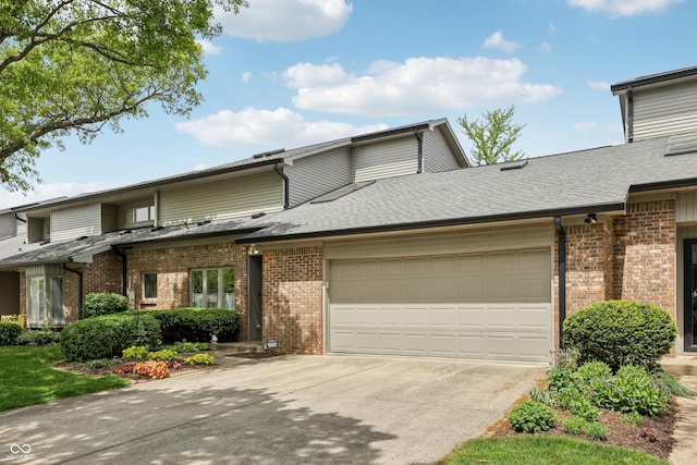 1030 Stratford Hall Unit 17-3, Indianapolis, IN 46260 - view of front of property with brick siding, an attached garage, and driveway