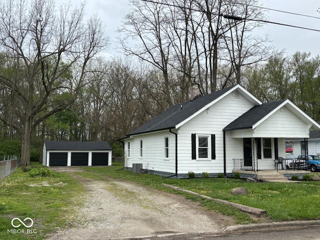 single story home with covered porch, a chimney, central AC unit, a garage, and an outdoor structure