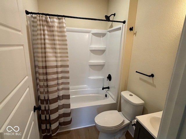 bathroom featuring vanity, wood finished floors, shower / bath combination with curtain, and toilet