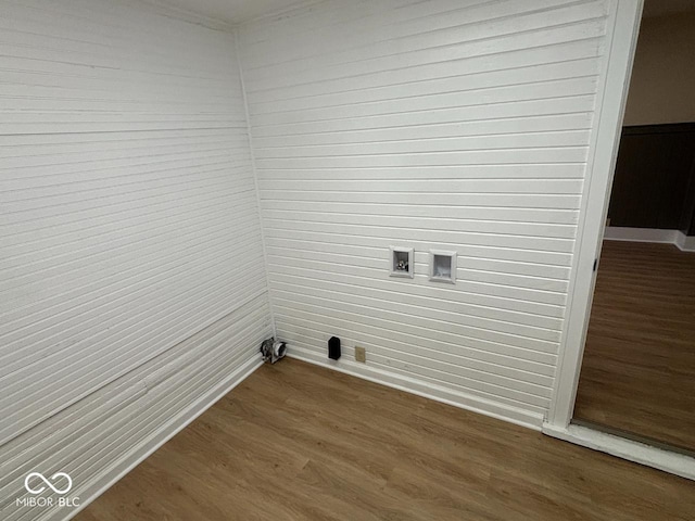 washroom with laundry area, wood finished floors, baseboards, hookup for a washing machine, and wooden walls