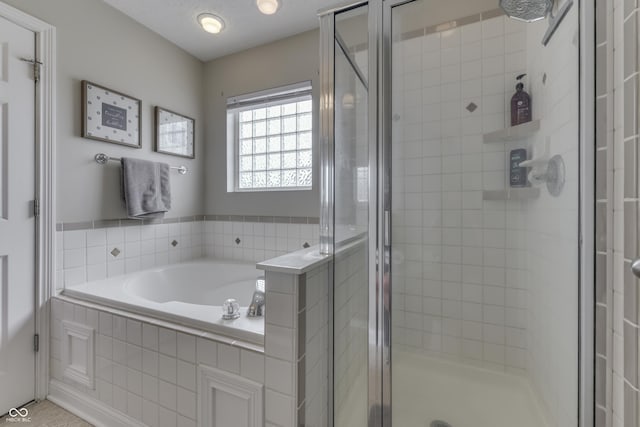 bathroom with a bath and a stall shower