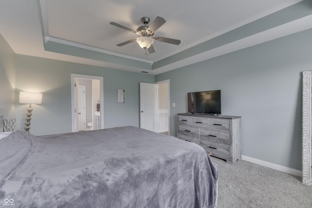 bedroom featuring a ceiling fan, crown molding, baseboards, light carpet, and a tray ceiling