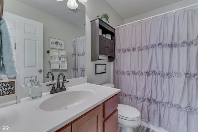 bathroom featuring vanity, curtained shower, visible vents, and toilet