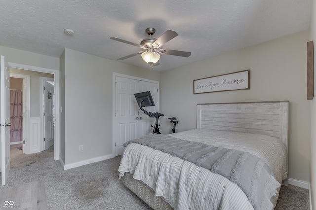 carpeted bedroom with baseboards, ceiling fan, and a closet
