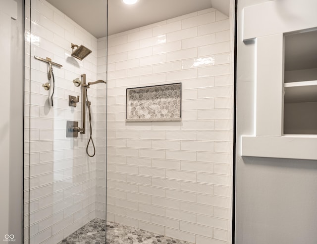 bathroom with a tile shower