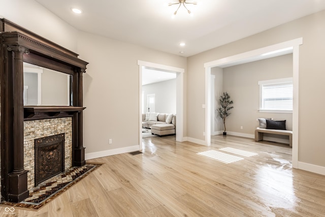 living area featuring visible vents, wood finished floors, a fireplace, baseboards, and recessed lighting